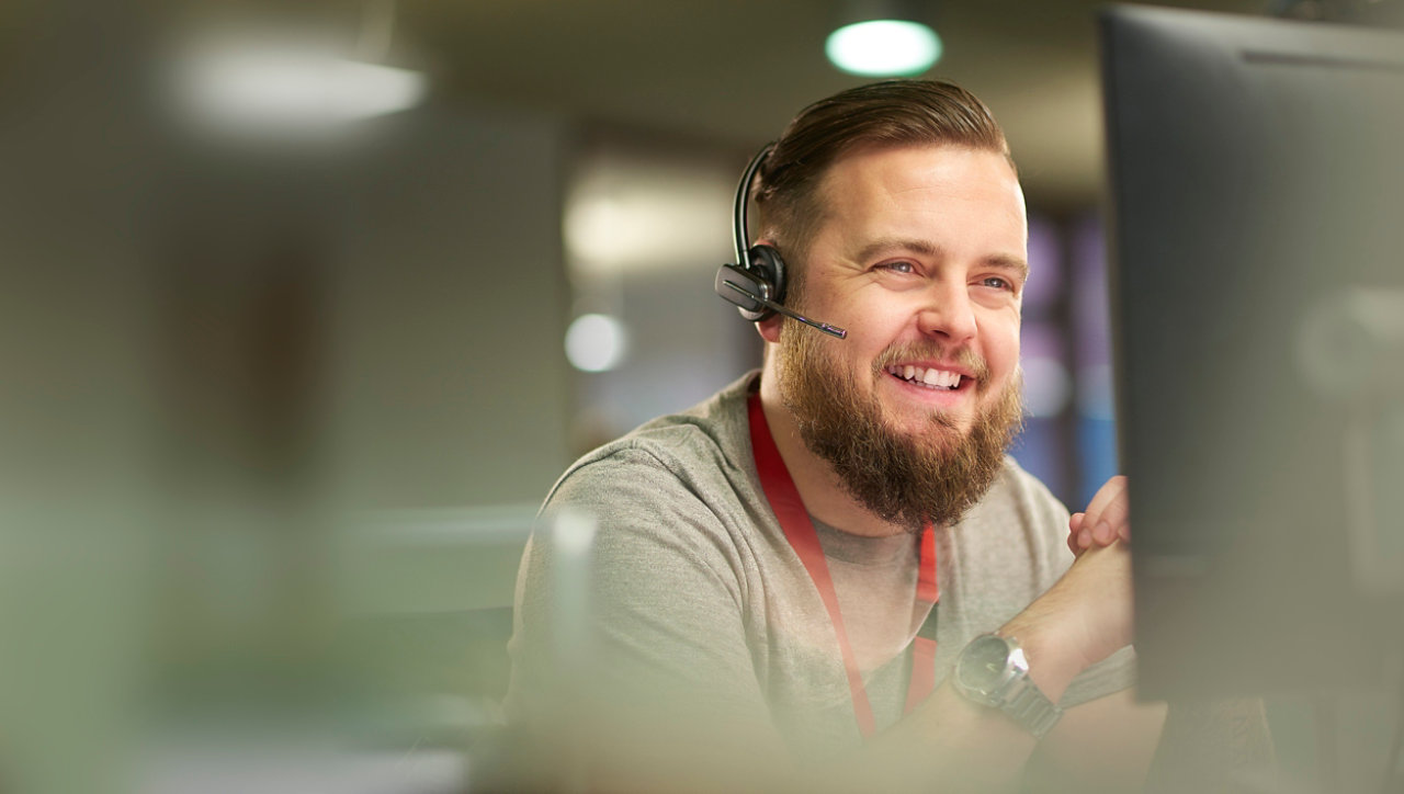 Man laughing in call center