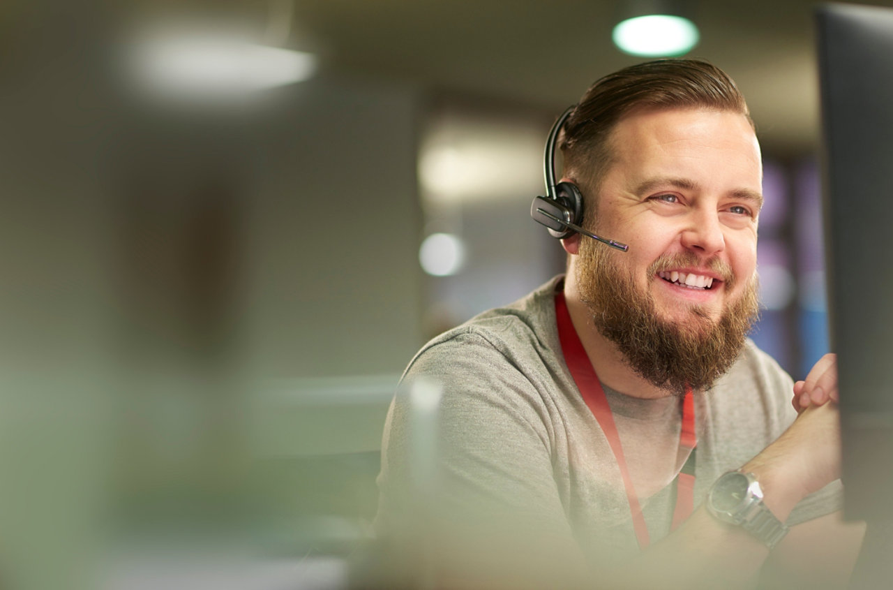 smiling man in customer service contact centre