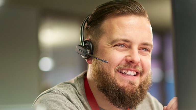 smiling man in customer service contact centre