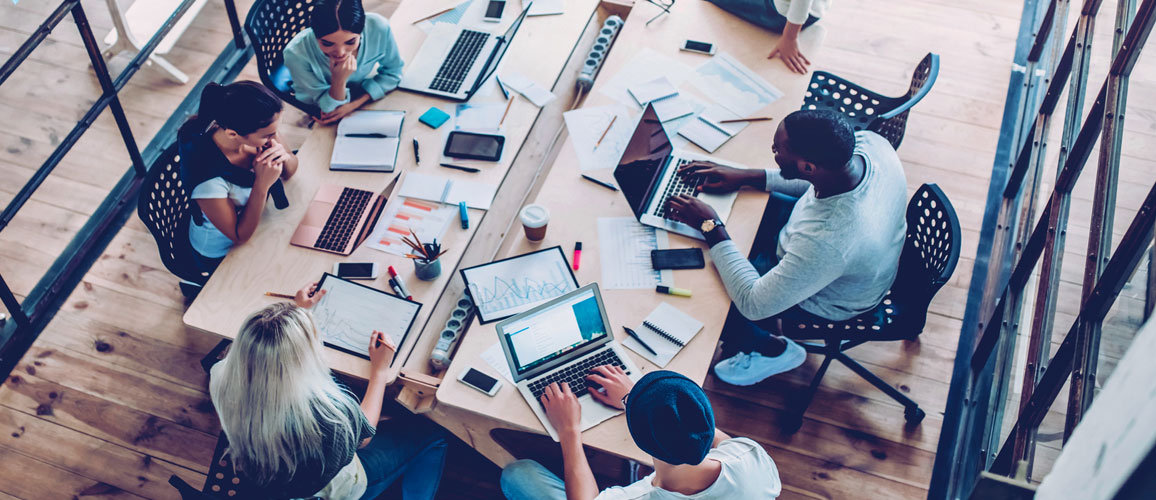 people working around a table in a office