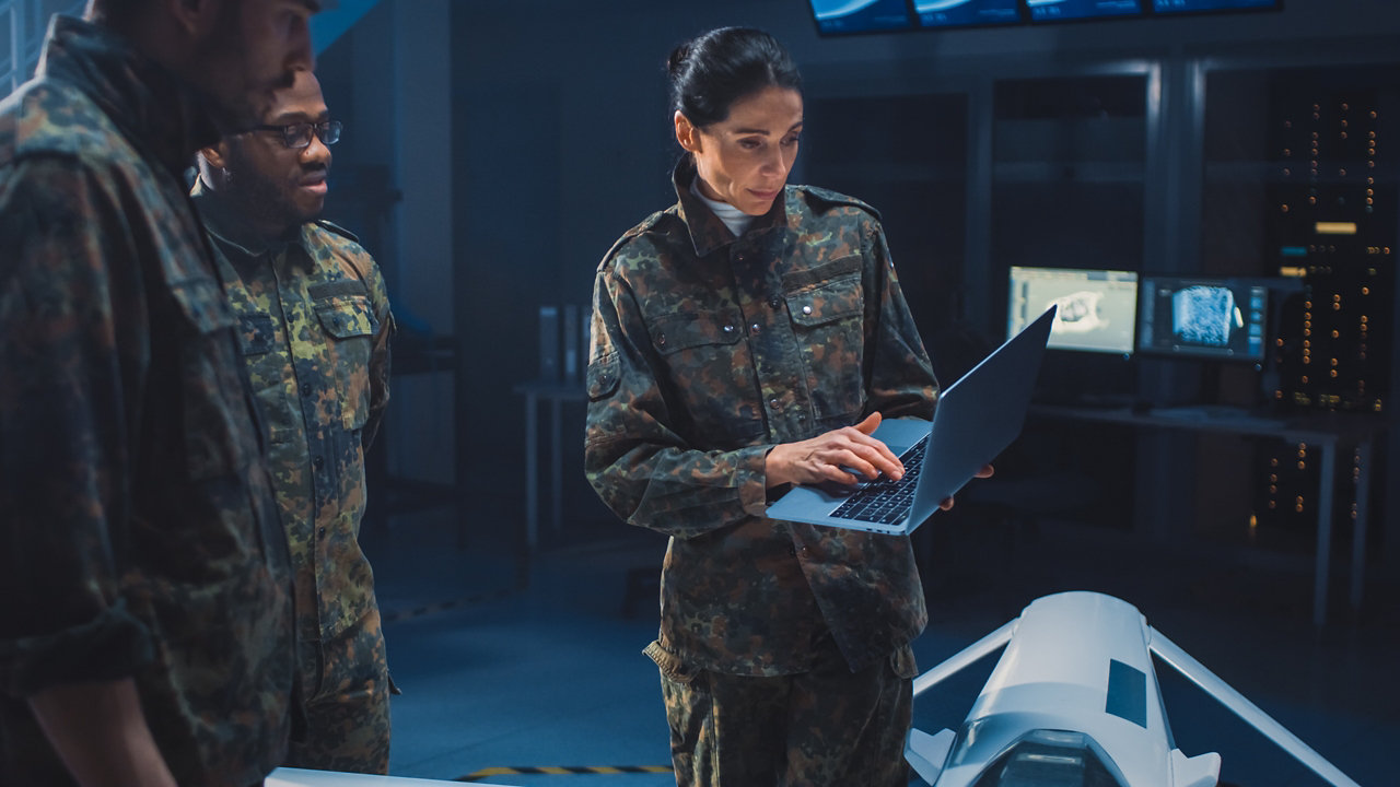 army officials looking at laptop screen