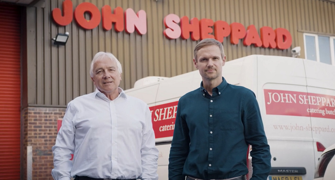 John Sheppard and son standing in front of a catering facility with van