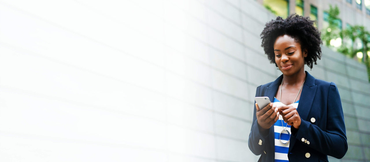 lady in a navy suit looking at her business mobile phone