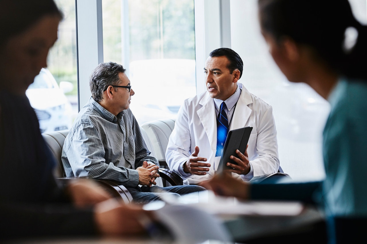 medical professional discussing with patenient in lobby