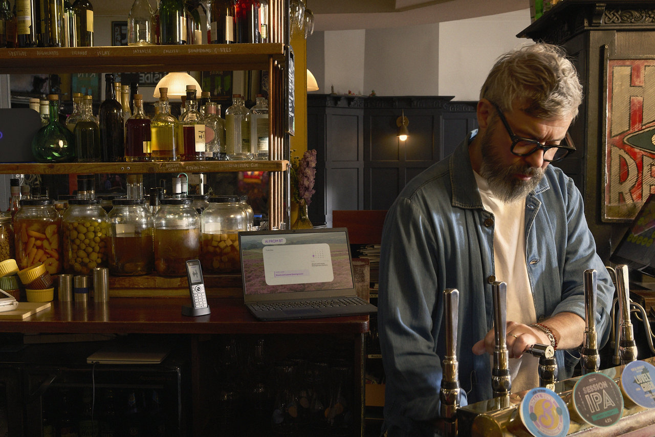 man holding phone on train/content/dam/bt-business/images/ai-adoption-hub/man-pouring-alcohol.jpg