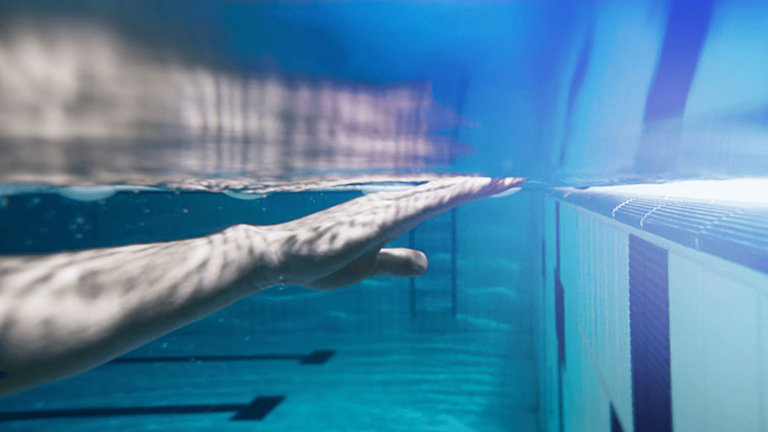 man swimming in pool