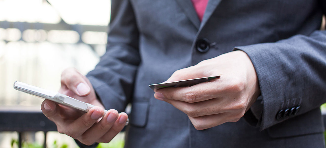 man with mobile phone and bank card