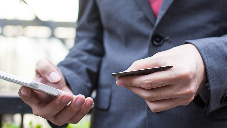 man with mobile phone and bank card
