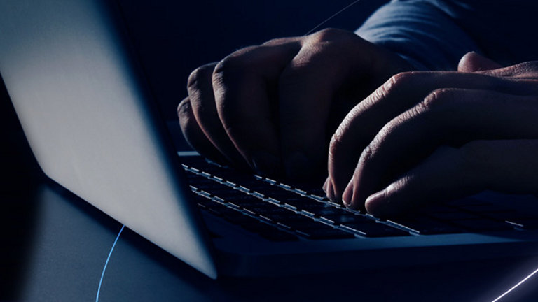 man typing on keyboard