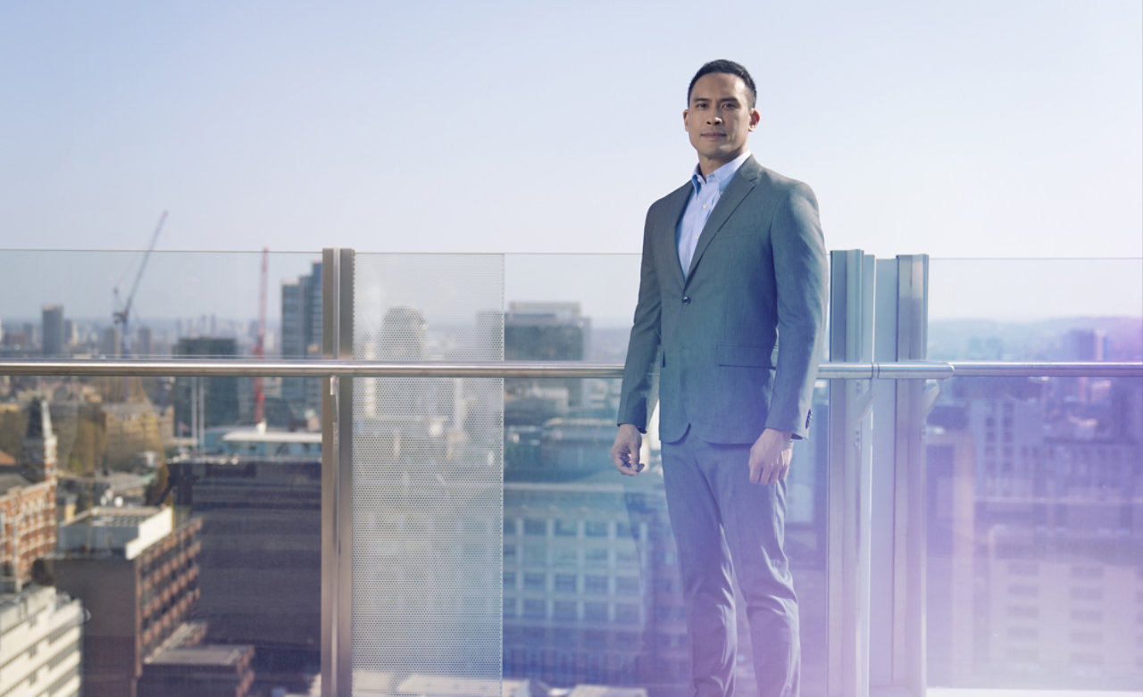 man in suit on balcony roof top