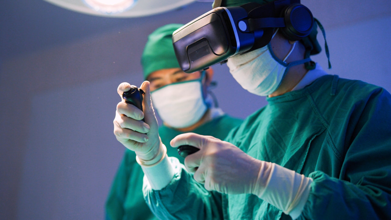 Professional surgeons in uniform and VR headset performing operation on patient in modern clinic.