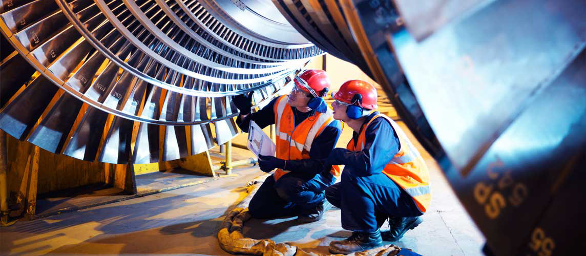 Two engineers inspecting machinery