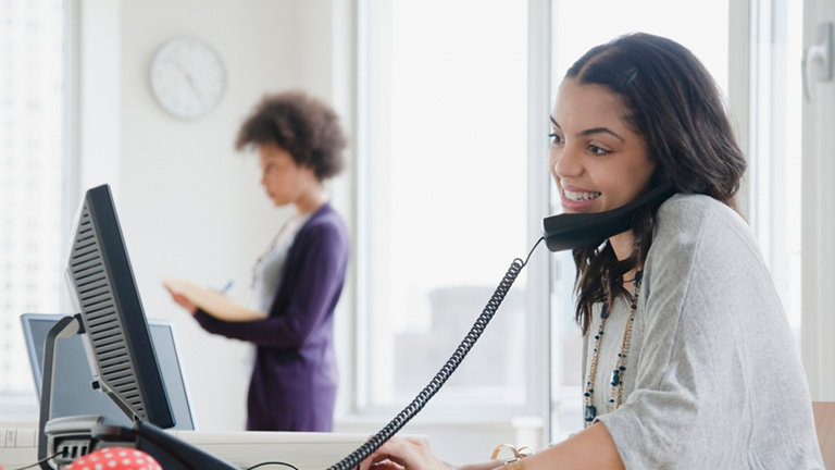 woman talking on telephone in office