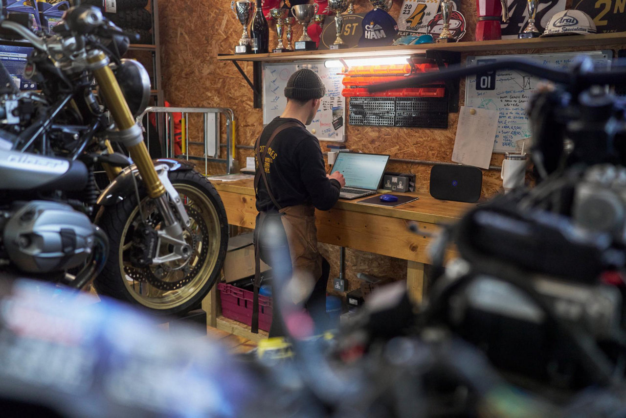 motorcycle shop worker using laptop