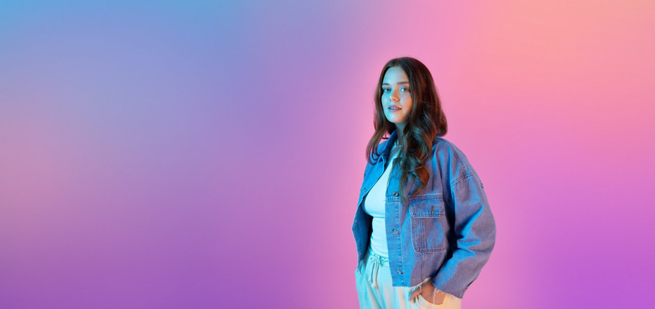 smiley man with headset in front of large screen