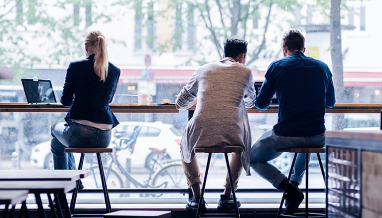 people in coffee shop window 