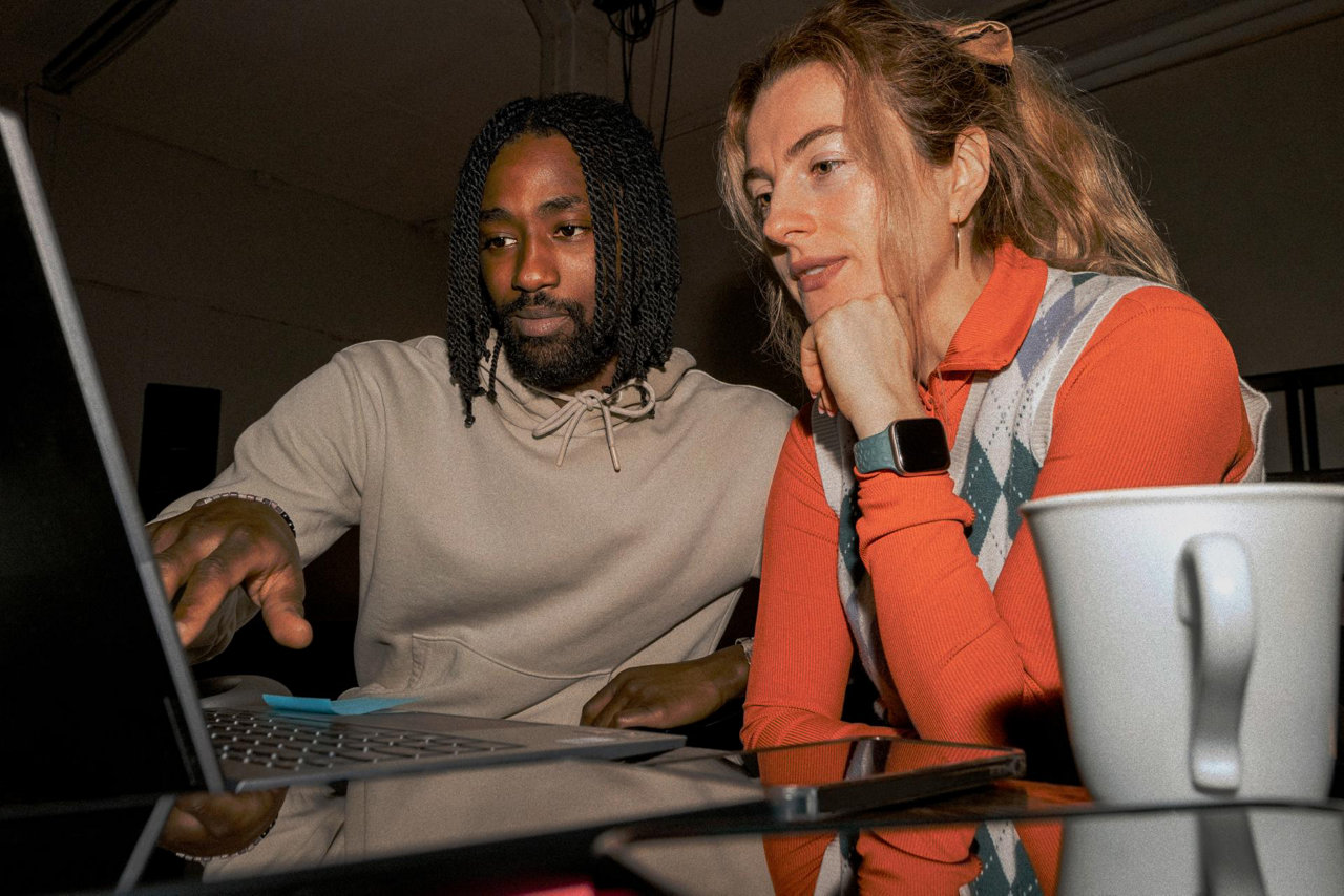 two people looking at a laptop screen