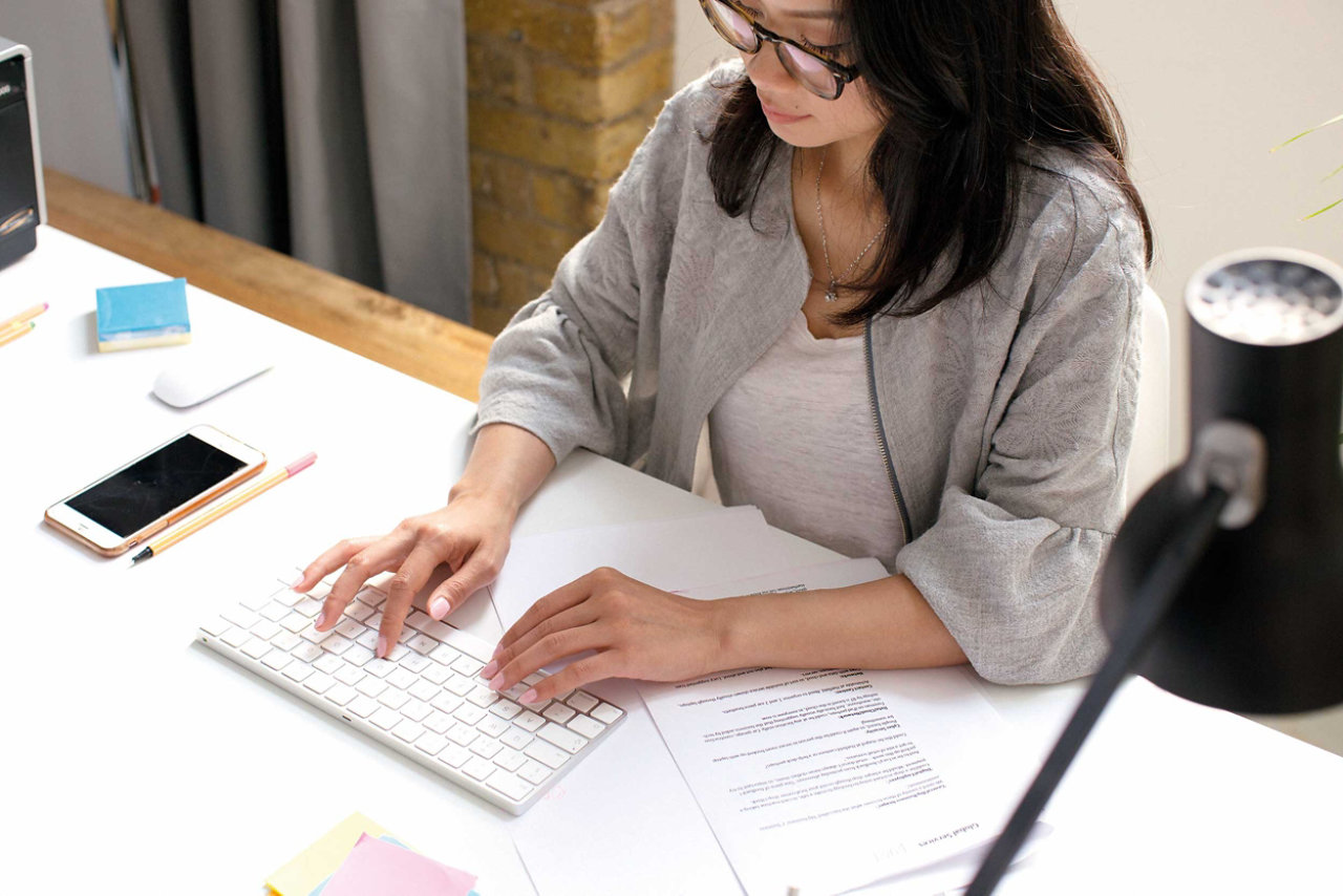 Executive manager posing seated at workplace desk