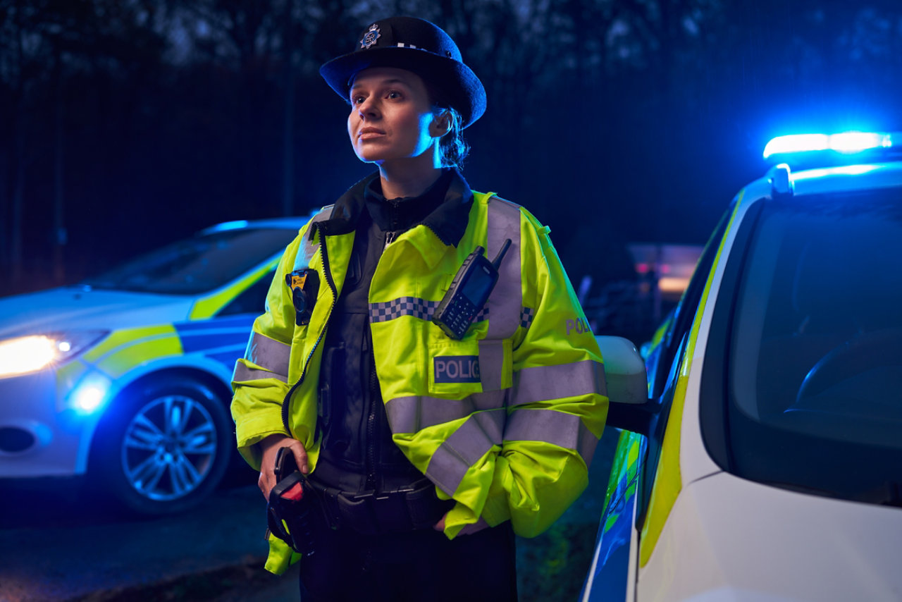two british policemen wearing traditional helmets
