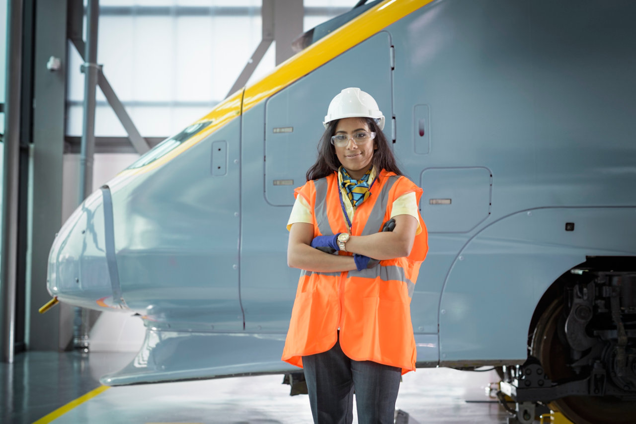 portrait of woman in front of locomotive 