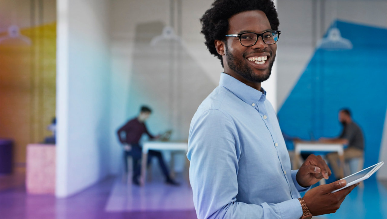 Employee standing in colorful office