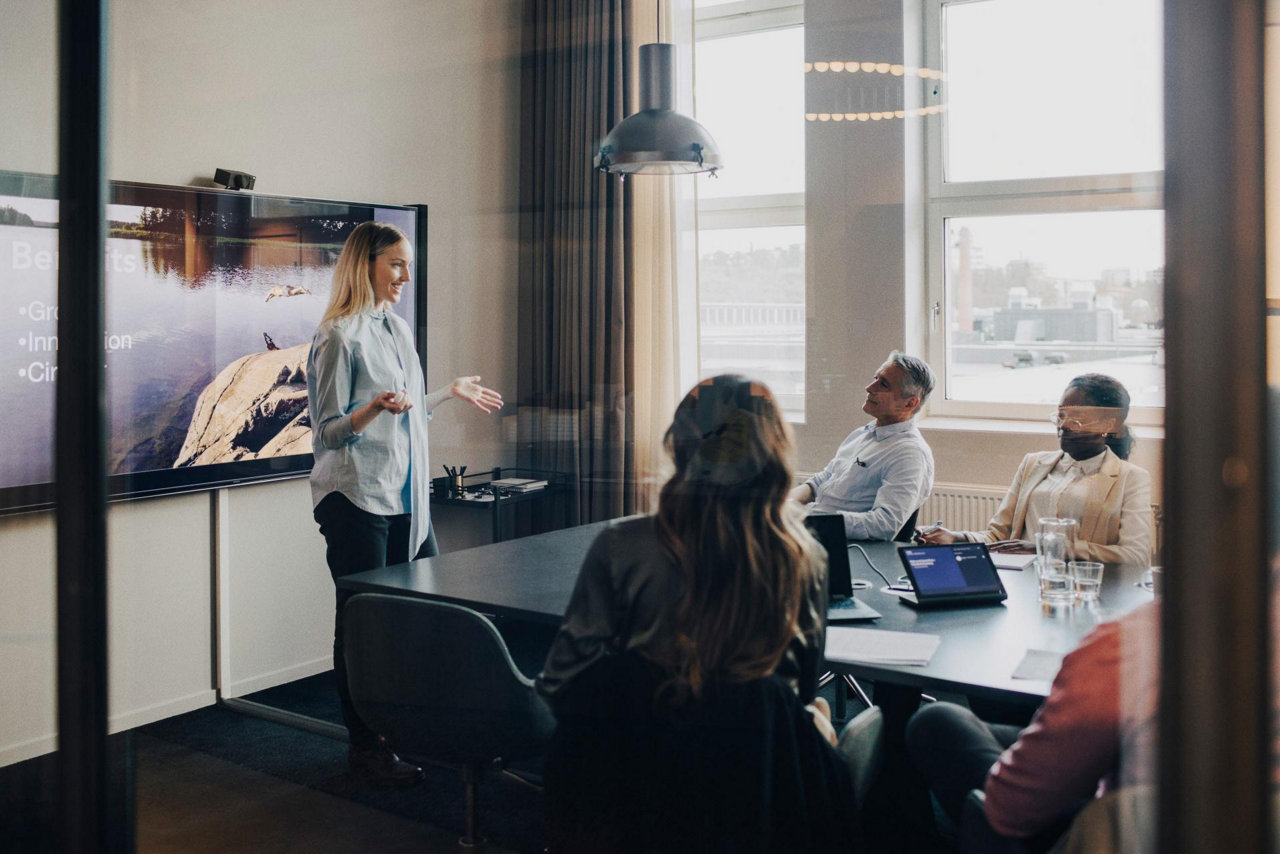 office workers in a presentation sitting around a table