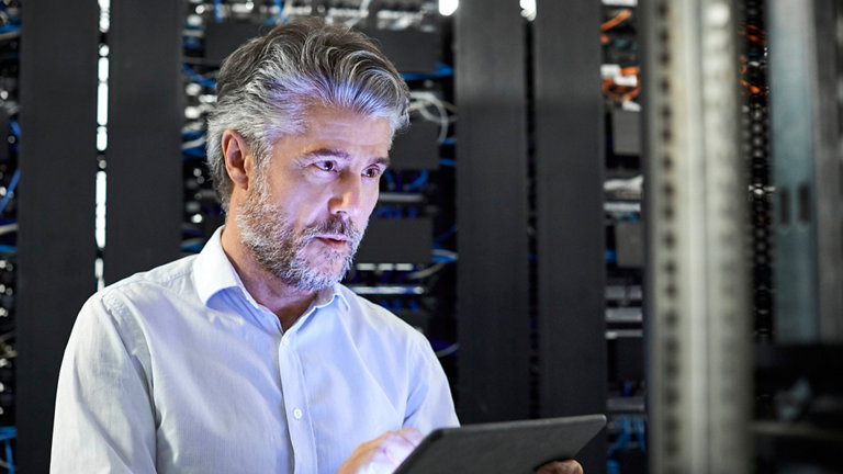 professional with digital tablet working in server