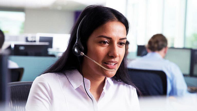 Woman in office on phone call