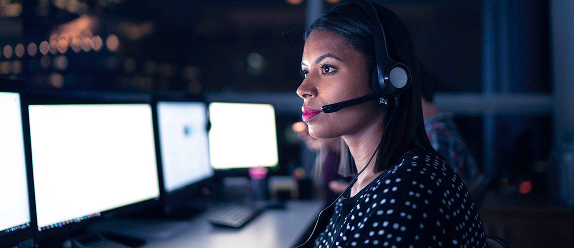 lady looking at screen wearing a headset