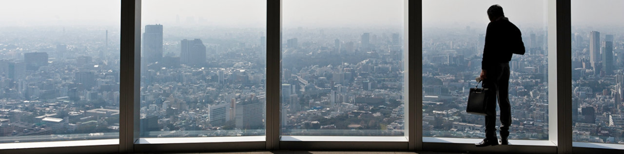 office employee looking out across the city