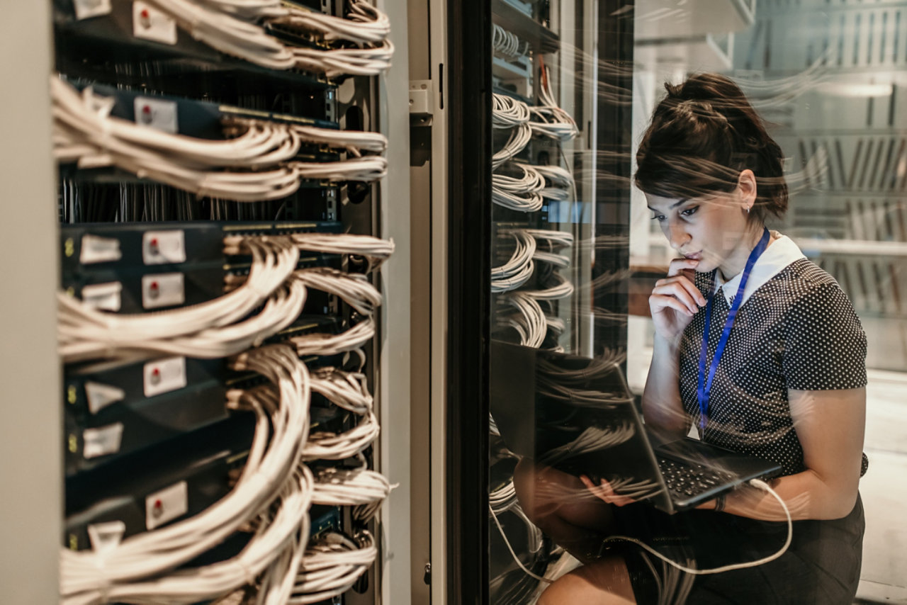 A worker investigating in a data centre