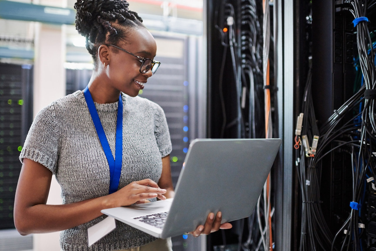 woman working on laptop in server room