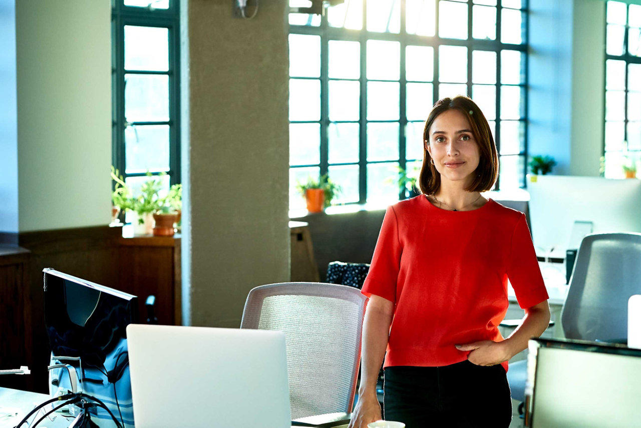 Small business owner in the office with devices connected to smart messaging