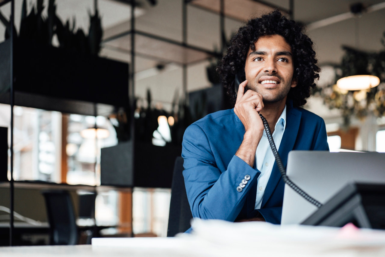 smiling man talking on phone