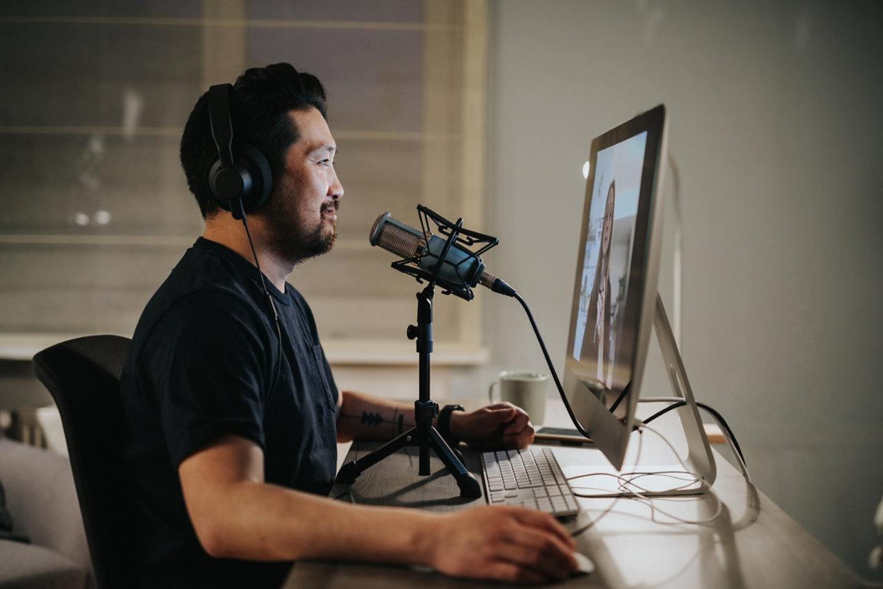 Smiling podcaster during video call