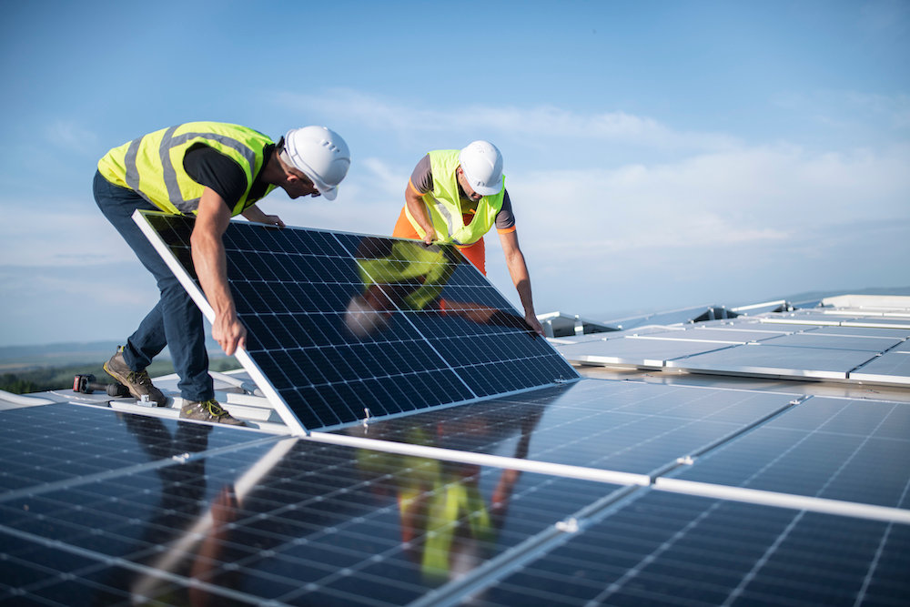 men installing solar panels