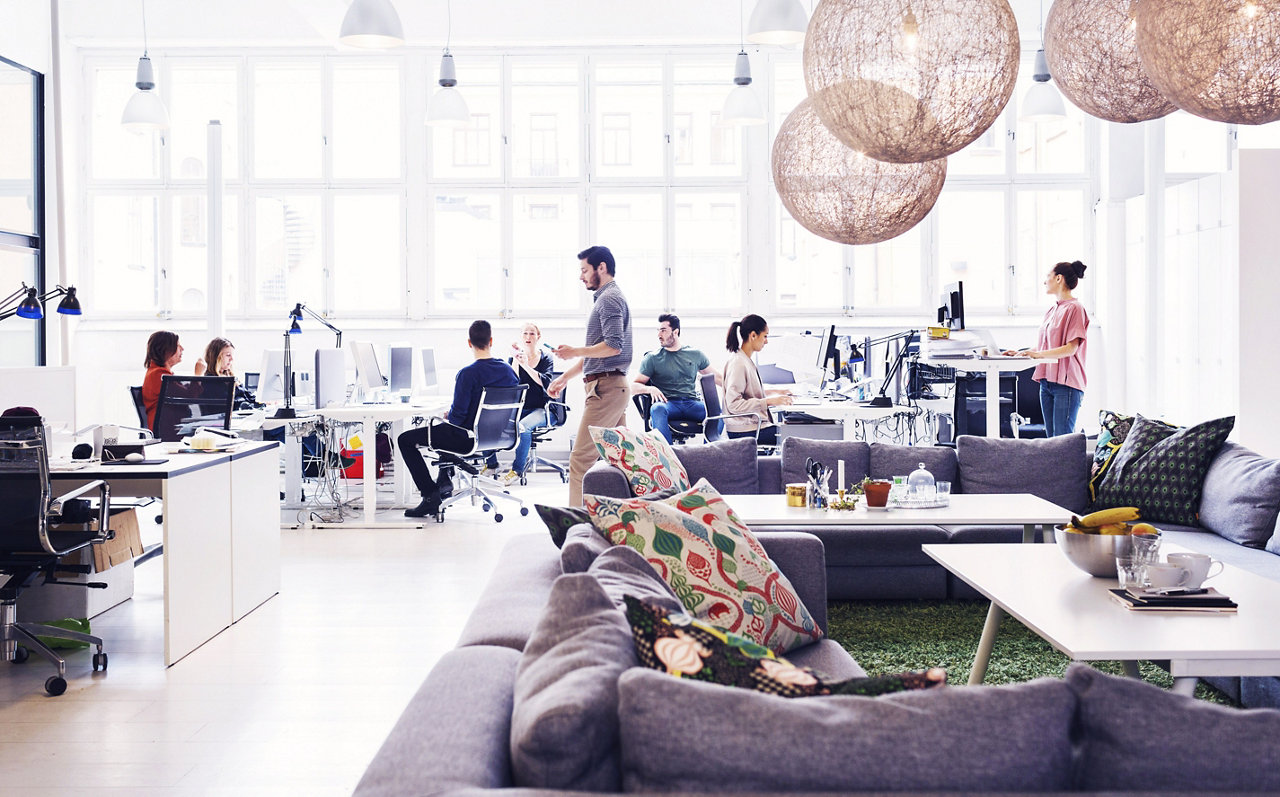 Man sitting in office at desk with lamp in background
