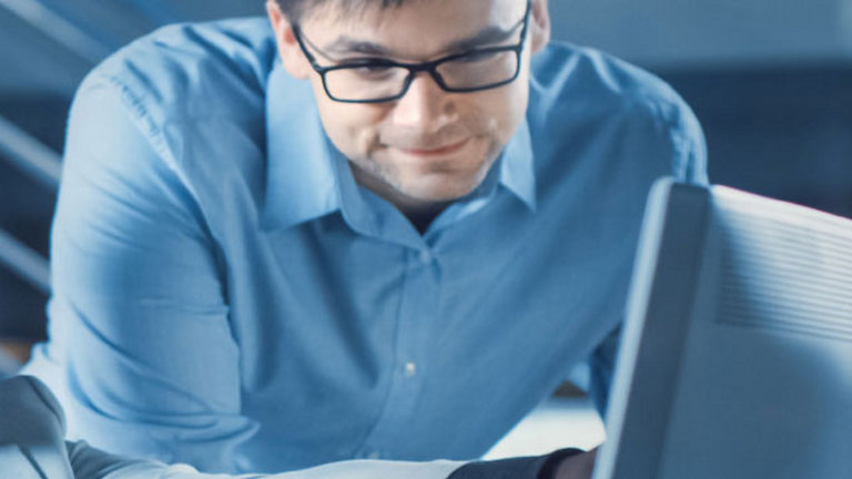 support workers surrounding a screen
