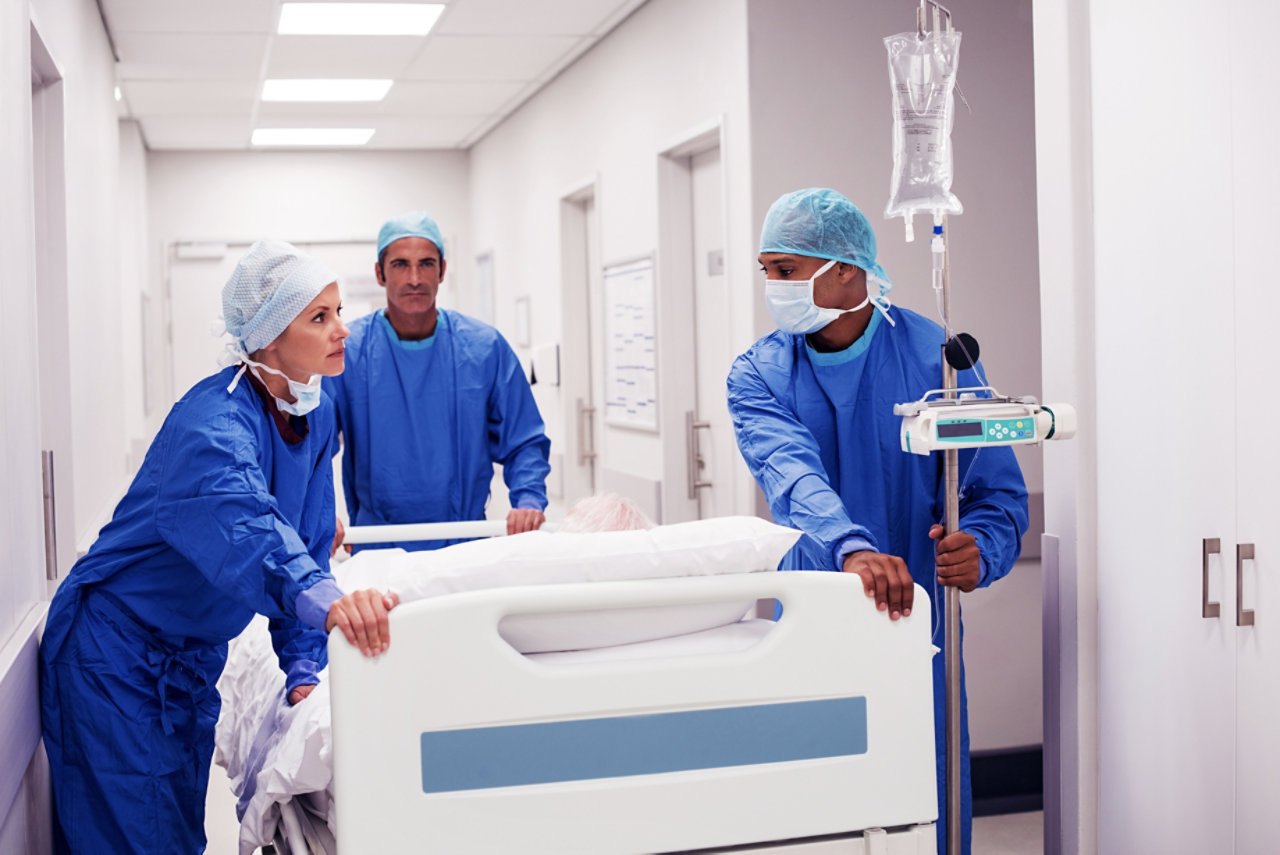 surgery team pushing patient