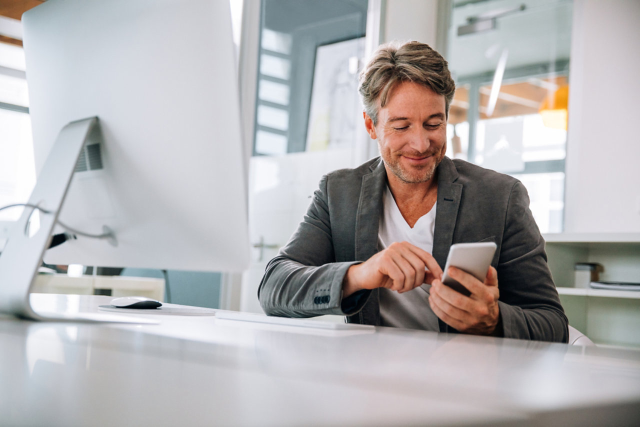 Businessman typing on smartphone