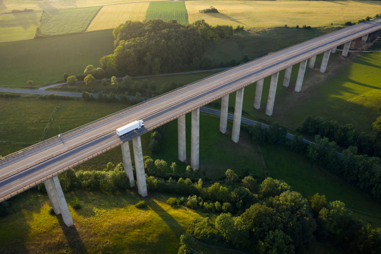 truck driving over high bridge