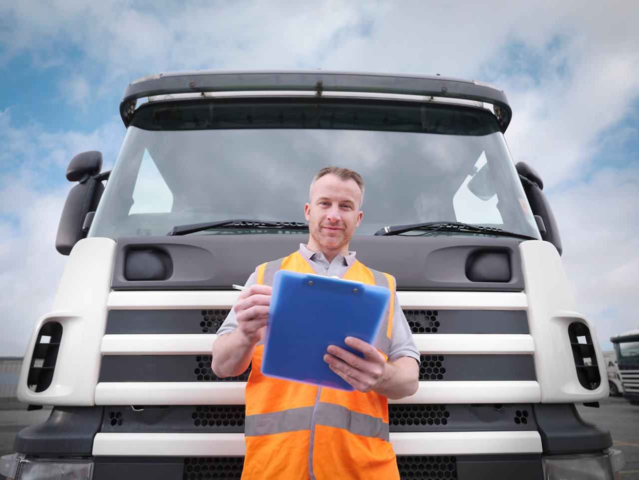 Truck driver checking notes