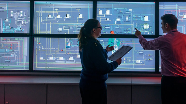 tutor and student in front of monitors in ships