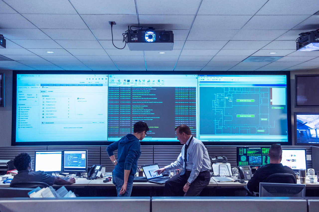 Two workers looking at a laptop screen