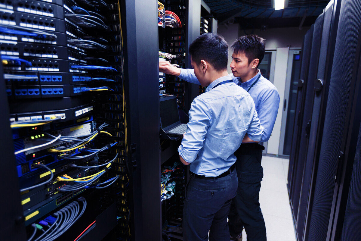 Two men working in a server room