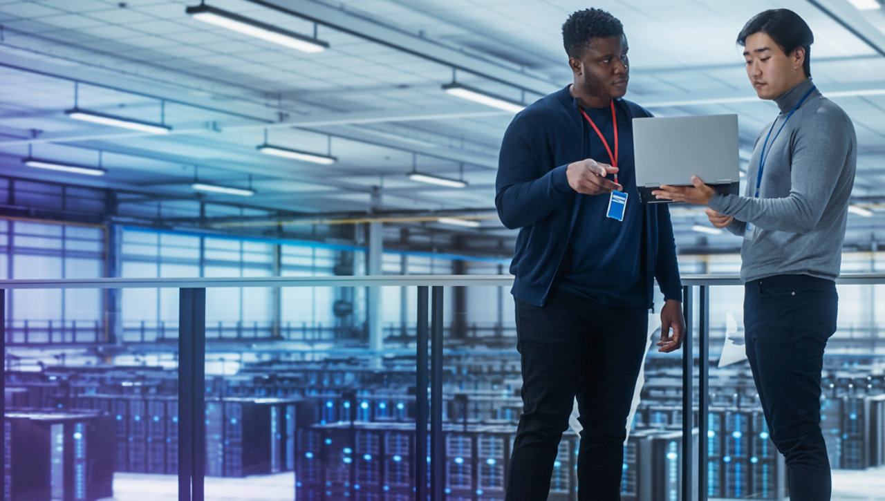 Two people in a data centre checking the firewall status