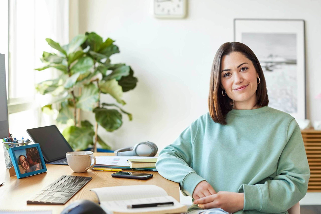 Small business owner in the office at the computer with VOIP solution