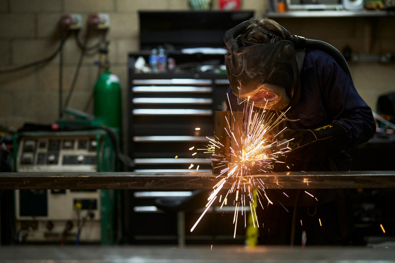 welder with mask and sparks flying