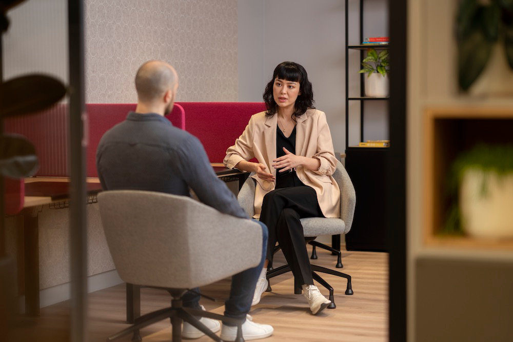 woman and man talking in formal setting