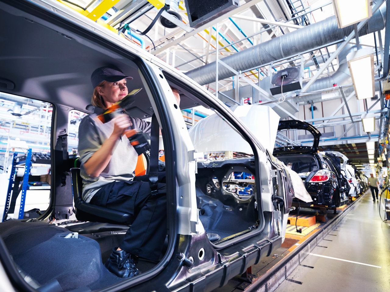 woman fixing car at the garage